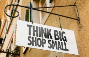 Close up of a sign that says think big shop small