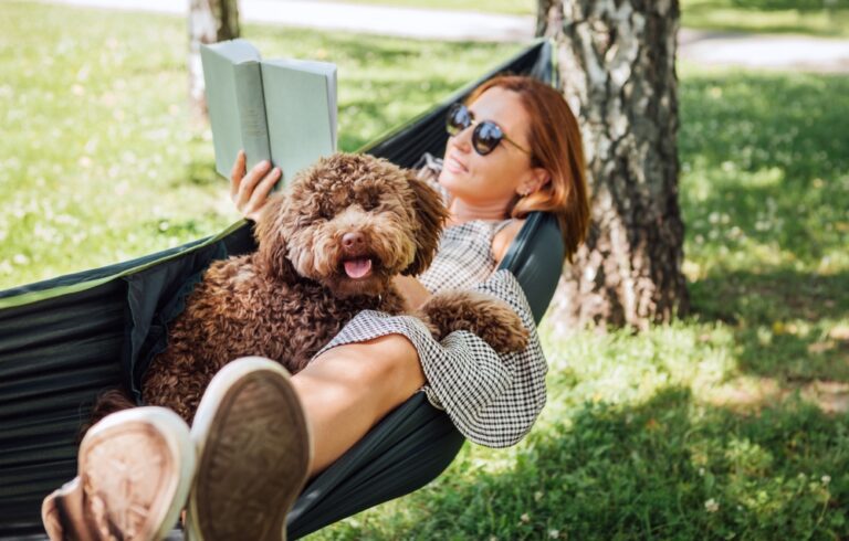 woman reading with a dog